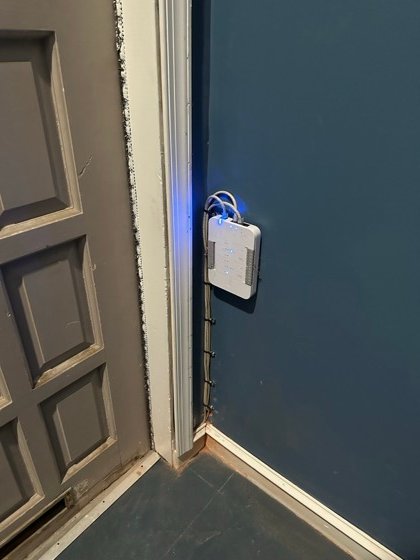 The access hub: door controller mounted and wired, every run dressed and secured.