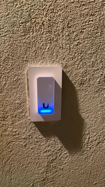 Close on the new reader: recessed plate, security screw, lit and reporting to the console.