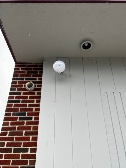 The same corner from below &mdash; the wireless link overhead, the camera covering the approach.