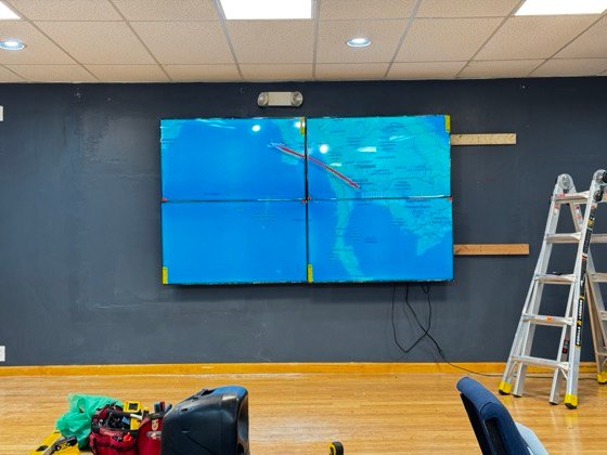 A single image spanning the full wall, seams aligned so the picture reads as one screen.